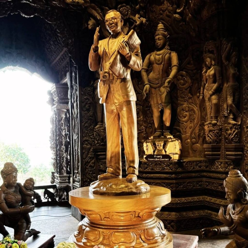 Lek Viriyaphan Statue im Sanctuary of Truth, Pattaya Statue von Lek Viriyaphan im Inneren des Sanctuary of Truth in Pattaya, umgeben von detaillierten, mythologischen Holzschnitzereien.